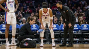 Dallas Wings player receiving medical attention for knee injury during WNBA game